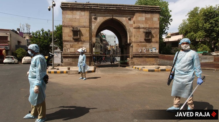 A day after 21 policemen in Ahmedabad were tested positive for Covid-19, the police force deployed in the walled city were given personal protective equipment (PPE) to keep guard on the roads during ongoing curfew on Sunday. (Express photo Javed Raja)