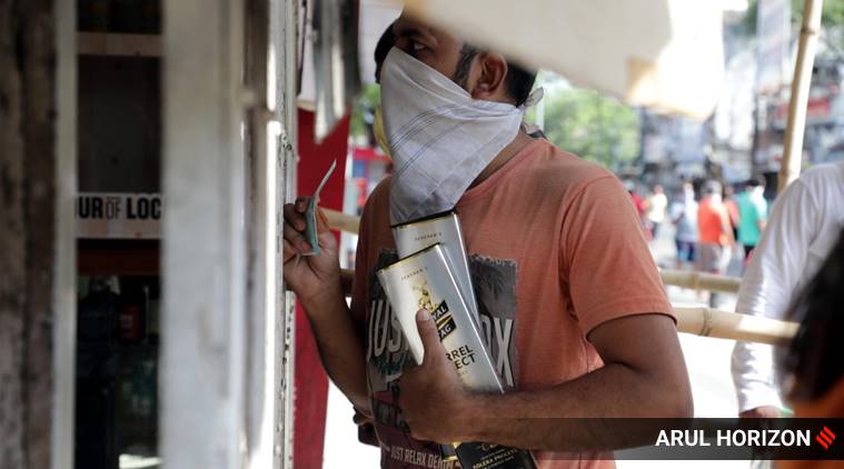 The long queue at the liquor shop on FC road  with barricades and other preventive measures on Wednesday during the lock down owing to the Pandemic COVID-19 outbreak. (Express photo by Arul Horizon)