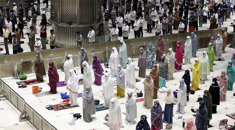 Indonesian Muslims pray spaced during an evening prayer called "tarawih" marking the first eve of the holy fasting month of Ramadan at Istiqlal Mosque in Jakarta, Indonesia. (AP Photo/ Achmad Ibrahim)