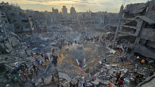 Palestinians search for casualties at the site of Israeli strikes on houses in Jabalia refugee camp