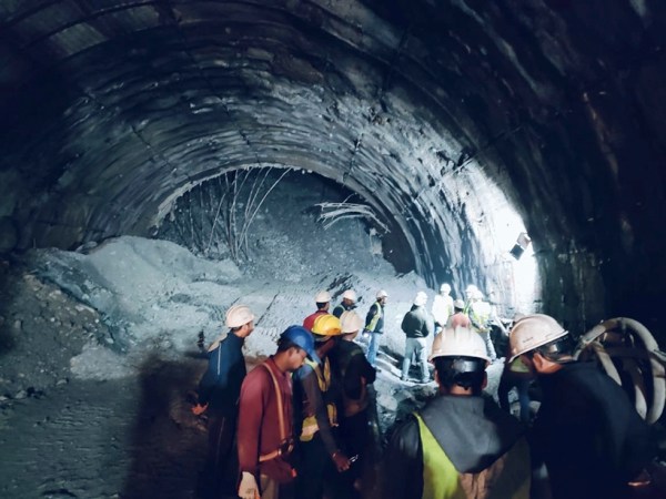 This photo provided by Uttarakhand State Disaster Response Force (SDRF) shows rescuers inside a collapsed road tunnel where more than 30 workers were trapped by a landslide in northern in Uttarakhand state, India, Sunday, Nov.12, 2023. ( SDRF via AP)