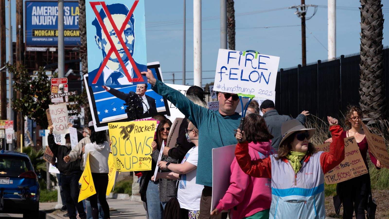 In pictures Hundreds protest outside Tesla showrooms over Musk’s role