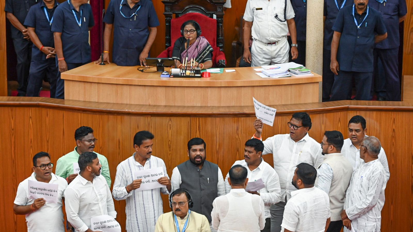 Congress legislators stage a protest at the Speaker's podium over women's safety during the Monsoon Session of the Odisha Assembly, on Wednesday. (PTI)